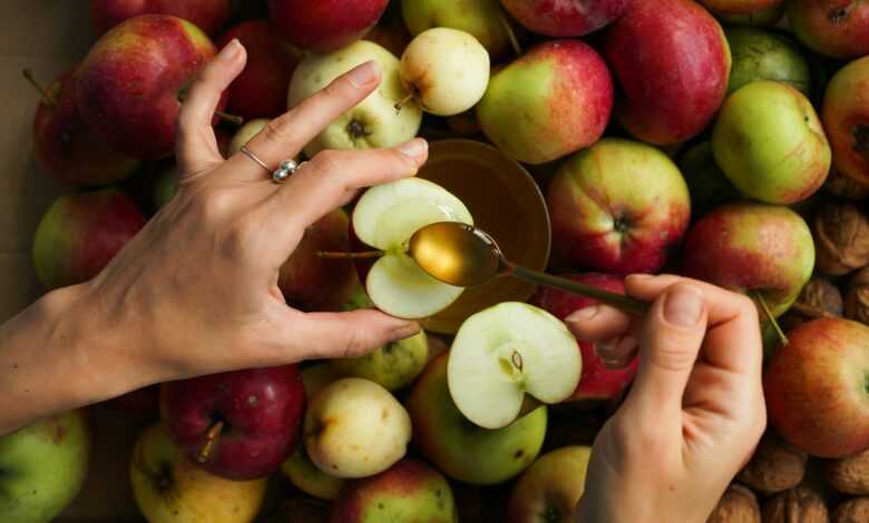 a person holding a bunch of apples