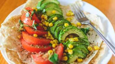 Sliced Tomato and Avocado on White Plate