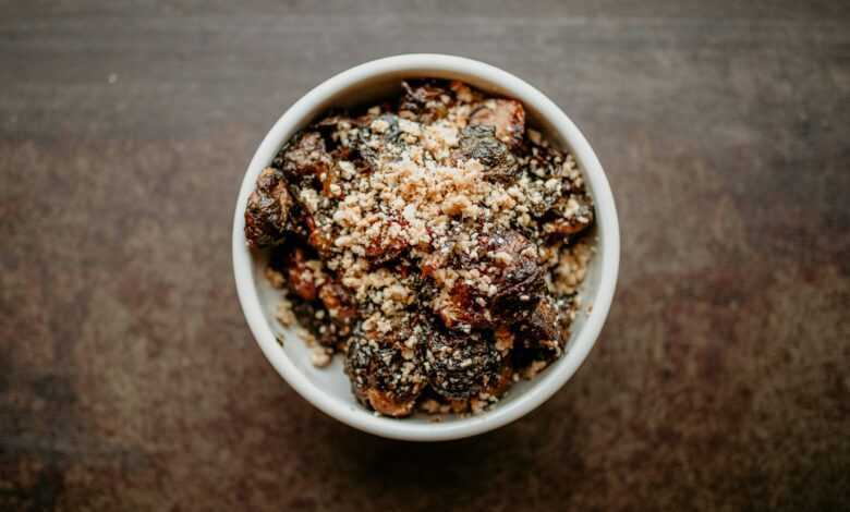 a white bowl filled with food on top of a wooden table