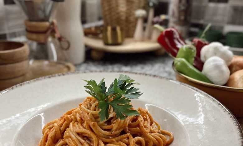 Warm plate of spaghetti with tomato sauce in a cozy kitchen setup, perfect for culinary enthusiasts.