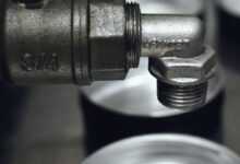 Detailed view of a rugged metal pipe fitting in an industrial setting.