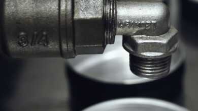Detailed view of a rugged metal pipe fitting in an industrial setting.