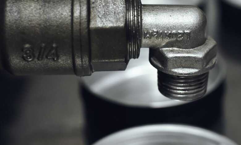 Detailed view of a rugged metal pipe fitting in an industrial setting.
