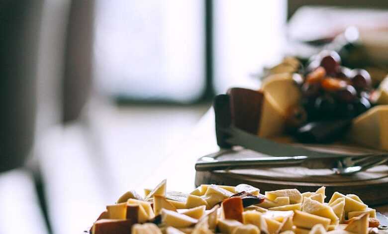 Delicious appetizers served on plates on wooden banquet table in cafeteria in light day