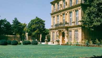 Old building with green lawn and bushes