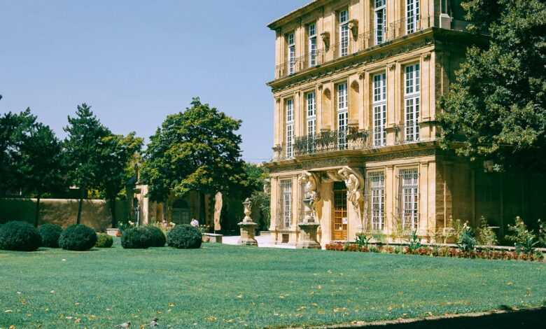 Old building with green lawn and bushes