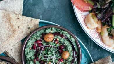 Appetizing assorted hummus served with mixed salad in cafe