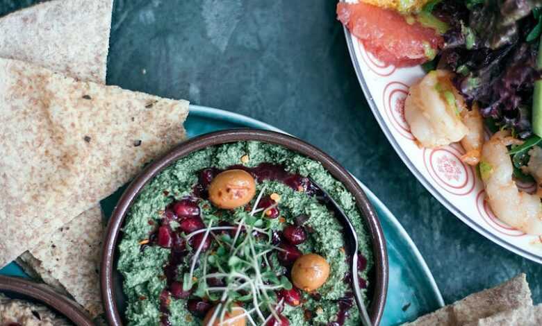 Appetizing assorted hummus served with mixed salad in cafe