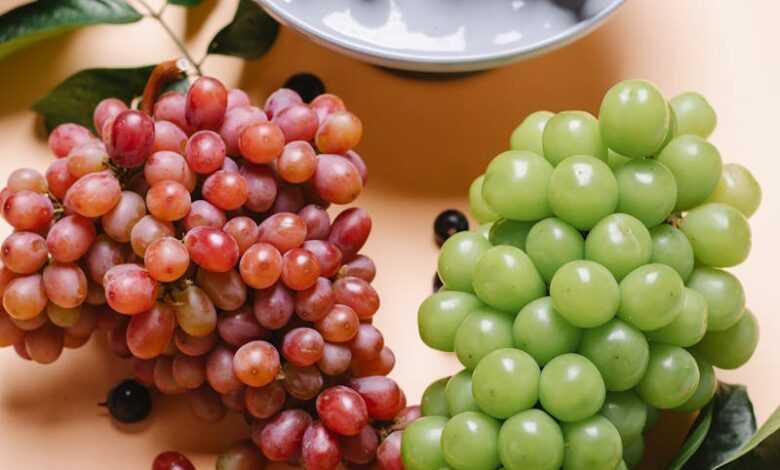 Delicious fresh grapes on table