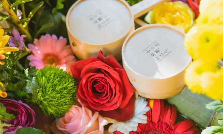 Japanese water basin with bamboo pipe and ladles decorated with colourful fresh flowers