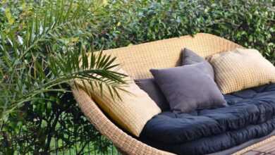 Stylish wicker sofa placed in patio