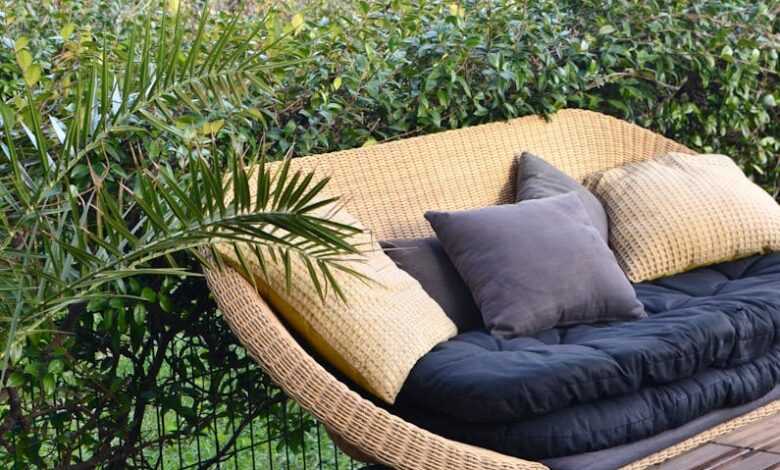 Stylish wicker sofa placed in patio