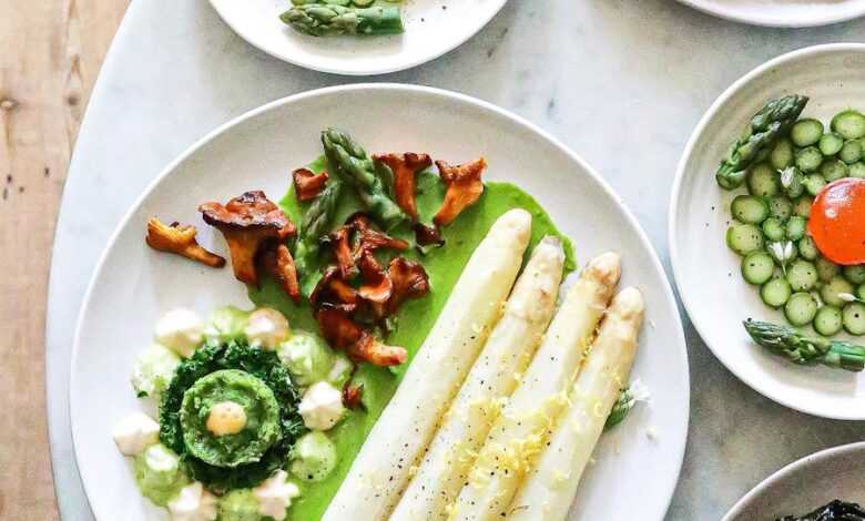 White asparagus with sauce near vegetarian dishes with herbs