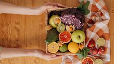 Person Holding A Basket Of Fruits