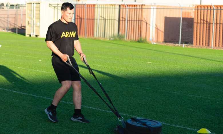 Man in Black T-shirt and Black Shorts Holding Black and Blue Stick