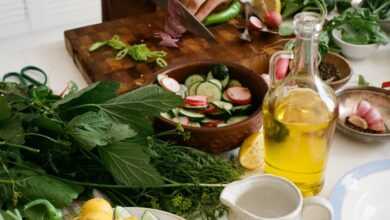 Person Slicing Vegetables on Chopping Board