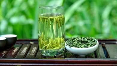 a glass of green tea next to a bowl of green tea