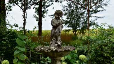 a statue of a person sitting on top of a fountain