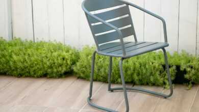 gray plastic armchair on green grass