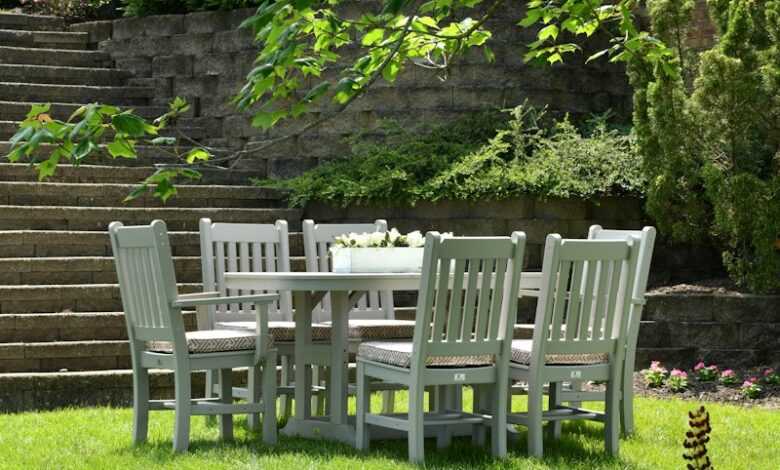 white wooden dining table with chairs set on grass