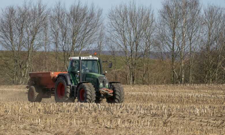 a tractor plowing a field of wheat