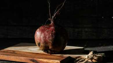 red and brown round fruit on brown wooden table