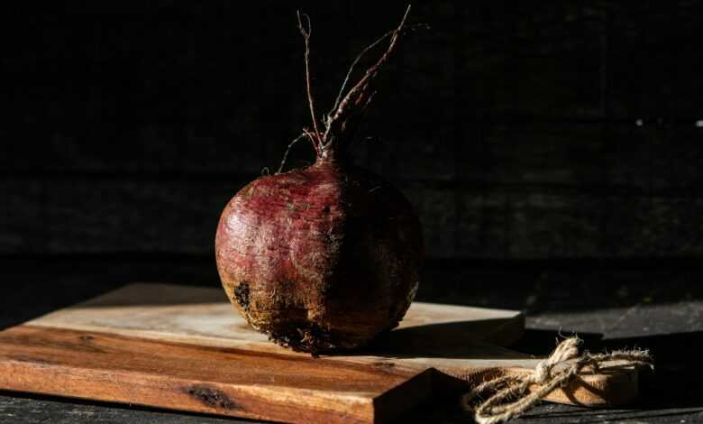 red and brown round fruit on brown wooden table