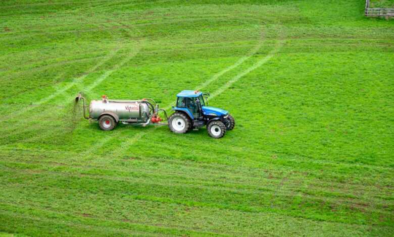 brown tractor on green grass field