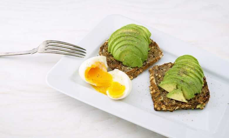 rectangular white platter of sliced food and eggs