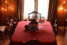 a dining table with a chandelier above it