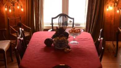 a dining table with a chandelier above it