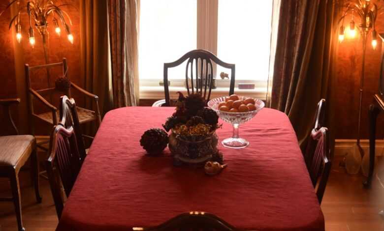 a dining table with a chandelier above it
