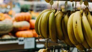 yellow banana fruit on black metal rack