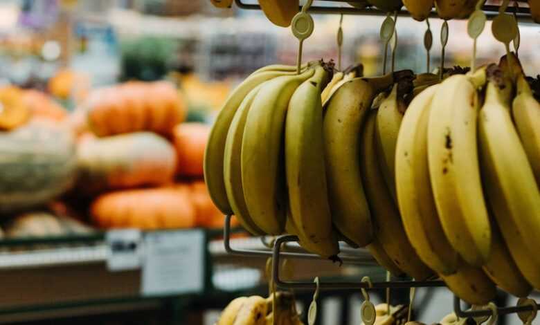 yellow banana fruit on black metal rack