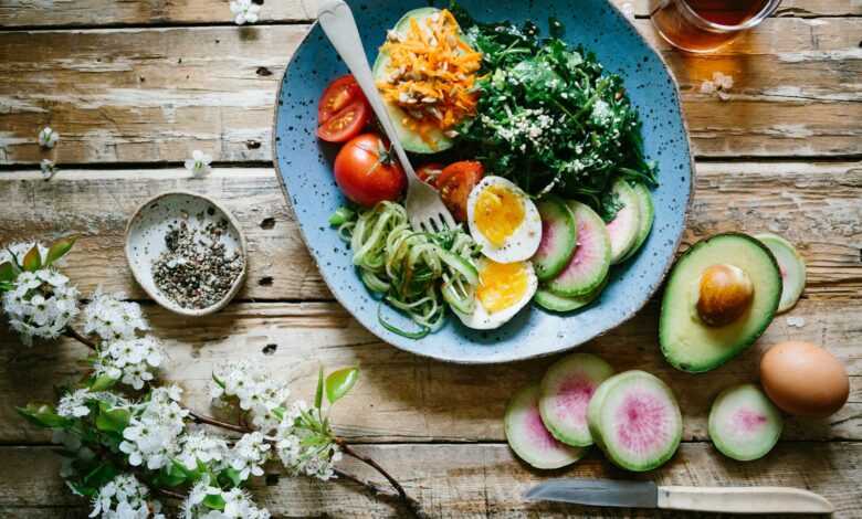 poached egg with vegetables and tomatoes on blue plate