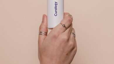 a person holding a white tube in their hand