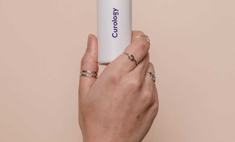 a person holding a white tube in their hand