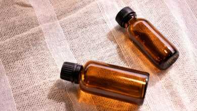 two small brown bottles sitting on top of a table