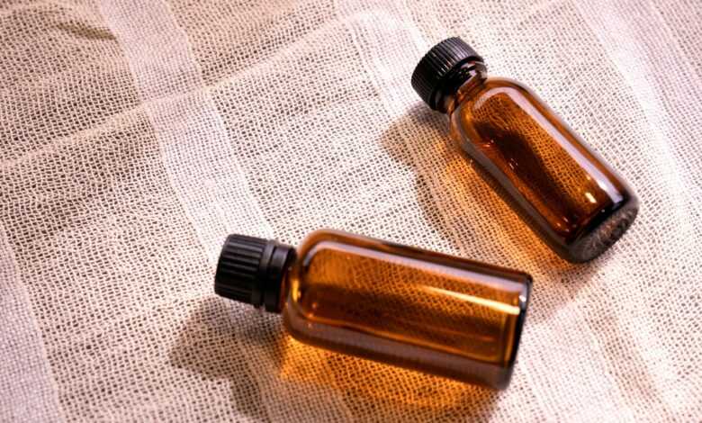 two small brown bottles sitting on top of a table