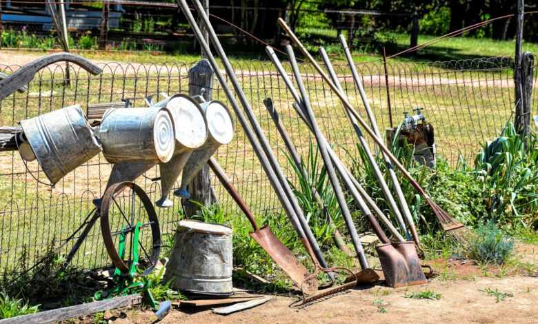 an old fashioned water pump sitting next to a fence