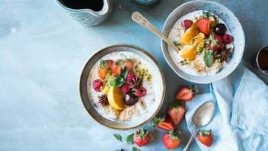 two bowls of oatmeal with fruits