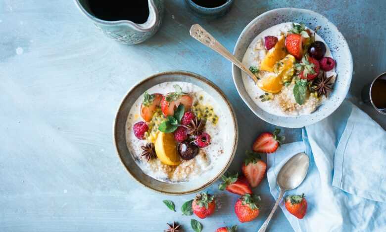 two bowls of oatmeal with fruits