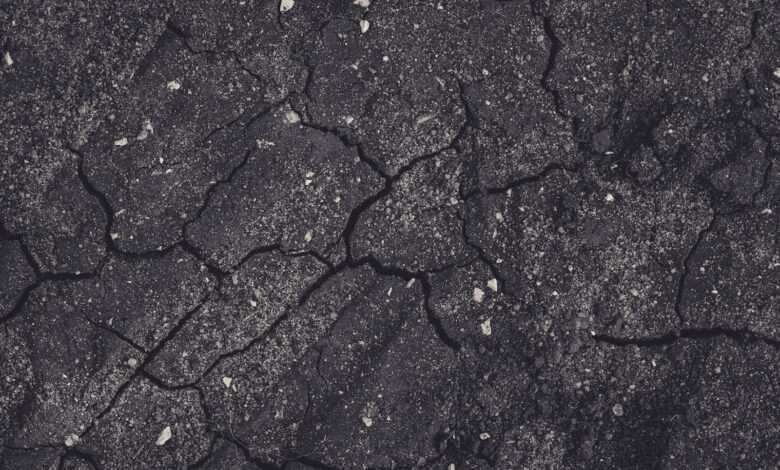 a black and white photo of a cracked surface