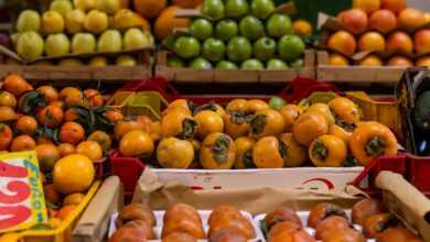 a fruit stand with oranges, apples, and other fruits