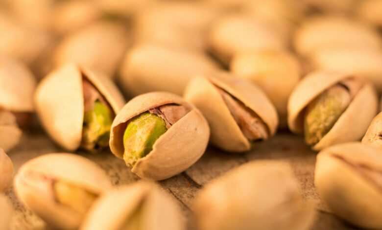 a pile of pistachio nuts sitting on top of a table